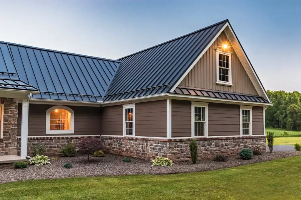 Metal roofing installation on a modern Troy home