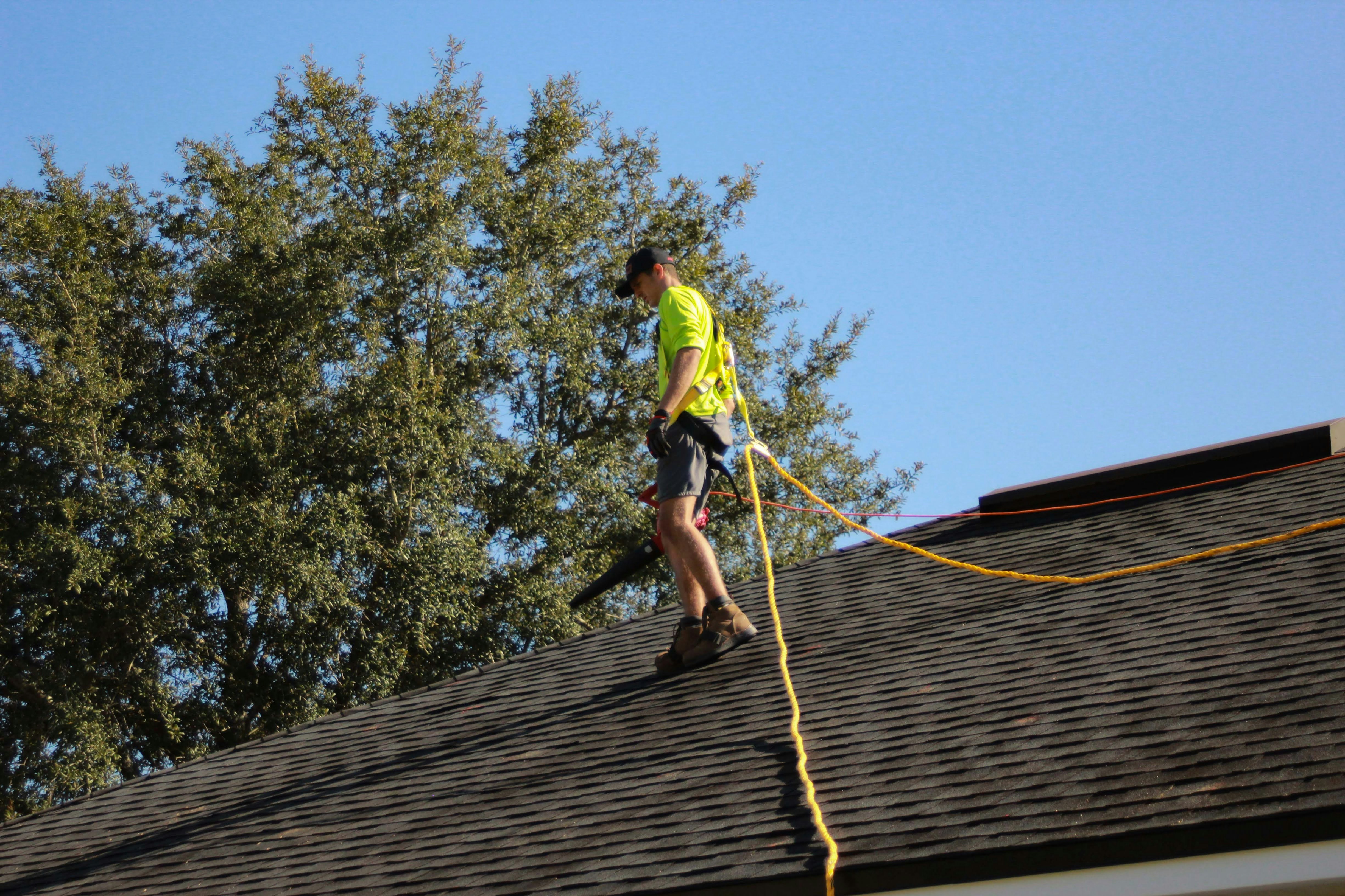 Roofing team installing shingles on residential home